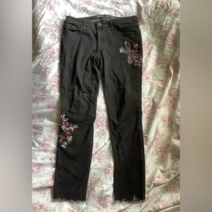 Black frayed mid-rise skinny jeans with floral embroidery